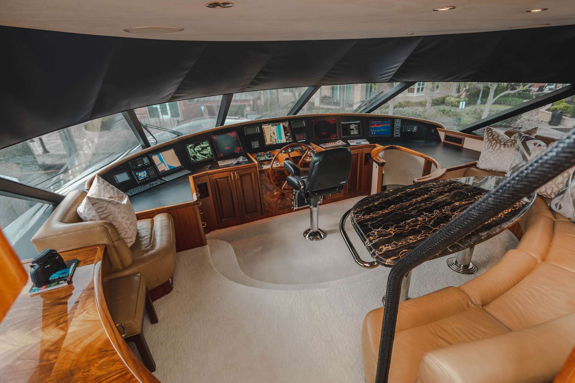 Bridge and navigation helm of the 112-foot Westport luxury yacht NOW OR NEVER featuring advanced navigation systems, captain’s helm, and panoramic views during a Bahamas yacht charter.